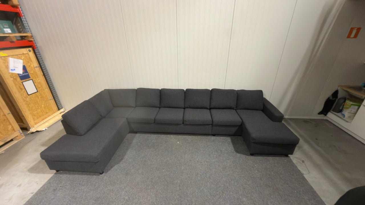 Begagnad svart U-soffa – plats för cirka 10 personer