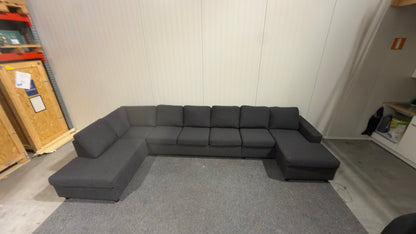 Begagnad svart U-soffa – plats för cirka 10 personer