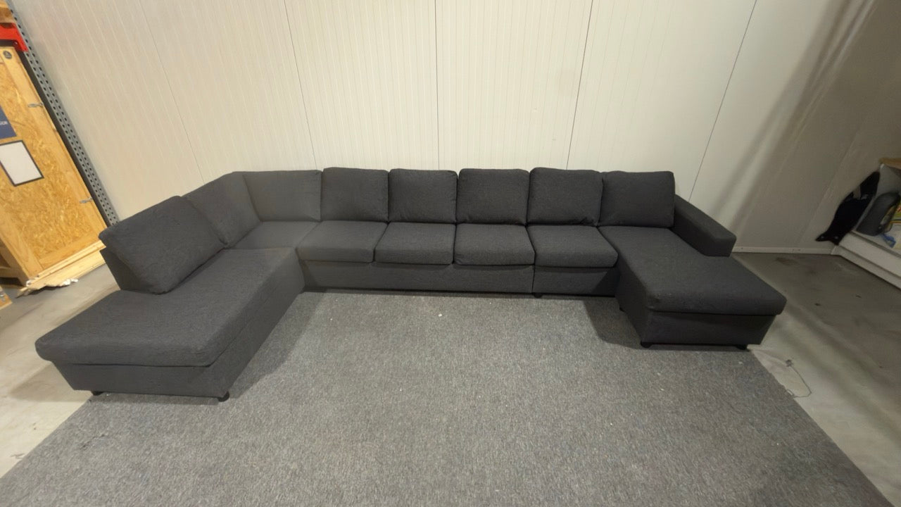 Begagnad svart U-soffa – plats för cirka 10 personer