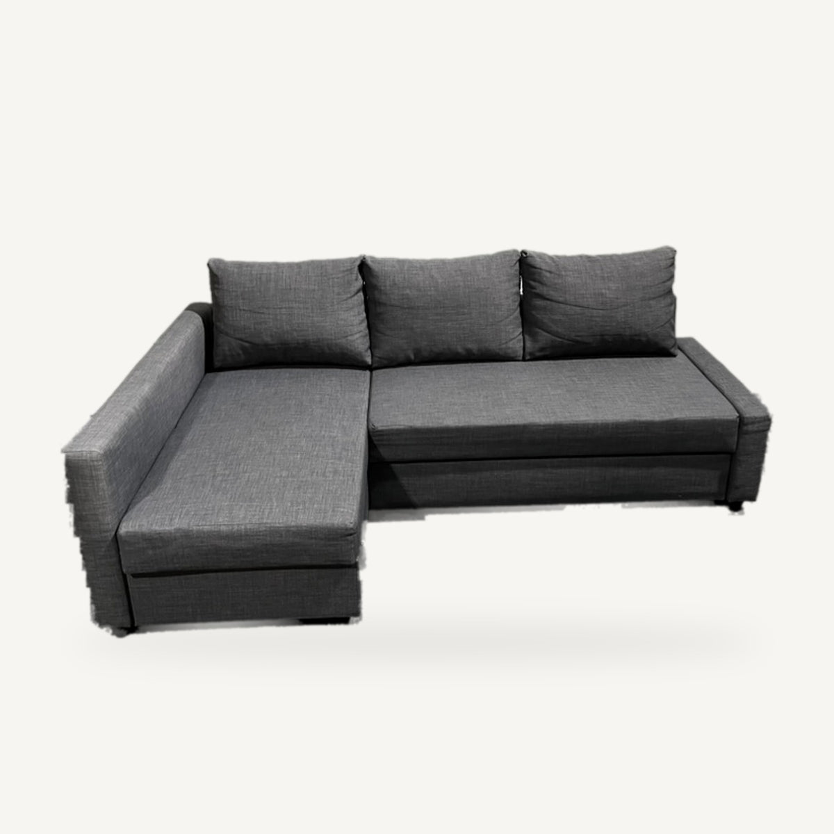 Begagnad IKEA FRIHETEN hörnbäddsoffa mörkgrå med divan till vänster snett framifrån